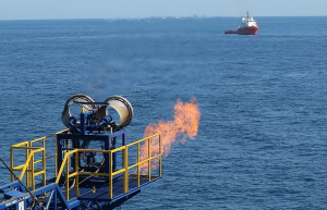 Waste gas flaring above the Pacific Ocean